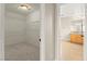 Walk-in closet connects to a bathroom with a wooden sink cabinet and tile floor at 3524 Colby Creek Ave, North Las Vegas, NV 89081