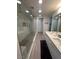 Modern bathroom showcasing a large glass enclosed shower and dual sink vanity at 353 E Bonneville Ave # 449, Las Vegas, NV 89101