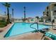 A large, well-maintained community pool is surrounded by lounge chairs and mature palm trees at 3550 Bay Sands Dr # 3089, Laughlin, NV 89029
