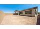Expansive backyard space featuring a covered patio, brick wall, and potential for landscaping at 364 Tigullio Ave, Henderson, NV 89011