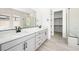 Modern bathroom with double vanity, sleek fixtures, and walk-in closet access at 364 Tigullio Ave, Henderson, NV 89011