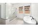 Bright bathroom with a glass-enclosed shower and separate soaking tub at 364 Tigullio Ave, Henderson, NV 89011