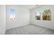 Bright bedroom features neutral carpet, white walls, and two sunny windows offering lovely outdoor views at 364 Tigullio Ave, Henderson, NV 89011