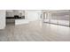 Open-concept living space with tile floors connecting to a modern kitchen area at 364 Tigullio Ave, Henderson, NV 89011