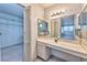 Bathroom vanity with marble countertop, cabinet storage, and large mirror, complemented by a spacious walk-in closet at 3930 University Center Dr # 412, Las Vegas, NV 89119