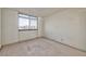Bright bedroom featuring neutral carpet, natural light, and a large window overlooking the cityscape at 3930 University Center Dr # 412, Las Vegas, NV 89119