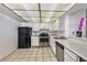 Functional kitchen with classic appliances, a tiled floor, and ample counter space at 3930 University Center Dr # 412, Las Vegas, NV 89119