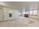 Bright living room with large windows, natural light, and a glimpse of the kitchen area at 3930 University Center Dr # 412, Las Vegas, NV 89119