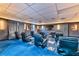 Home theater room with comfortable seating, blue carpet, and a large screen for entertainment at 3930 University Center Dr # 412, Las Vegas, NV 89119