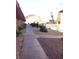 The exterior of the community features attractive landscaping, a fenced pool and sidewalks at 4421 Alexis Dr # 436, Las Vegas, NV 89103