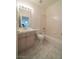 This bathroom is equipped with a single sink vanity and a shower over the bathtub at 4654 Stuttgart St, Las Vegas, NV 89147