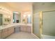 Bright bathroom featuring a double sink vanity and a glass-enclosed shower at 4654 Stuttgart St, Las Vegas, NV 89147