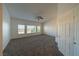 Large carpeted bedroom with ceiling fan and large windows at 4654 Stuttgart St, Las Vegas, NV 89147