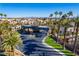View of the community entrance showcasing palm trees and meticulously maintained landscaping. City skyline in the background at 4654 Stuttgart St, Las Vegas, NV 89147