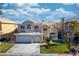 Charming two-story home features a three-car garage, a well manicured lawn, and a beautiful tiled roof at 4654 Stuttgart St, Las Vegas, NV 89147