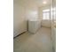 Bright laundry room with tile flooring, window, washer, dryer, and storage at 4654 Stuttgart St, Las Vegas, NV 89147