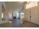 Open-concept living room boasts a fireplace, large windows and modern gray laminate floors at 4654 Stuttgart St, Las Vegas, NV 89147