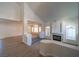 Open-concept living room boasts a fireplace, large windows and modern gray laminate floors at 4654 Stuttgart St, Las Vegas, NV 89147