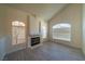 Inviting living room with large windows, a fireplace and modern gray laminate floors at 4654 Stuttgart St, Las Vegas, NV 89147
