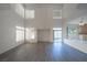 Bright, open living area with high ceilings, large windows, and sliding glass door at 4654 Stuttgart St, Las Vegas, NV 89147