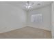Neutral bedroom with carpeted floors, a ceiling fan, and natural light at 4828 Marco Polo St, North Las Vegas, NV 89031