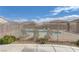 Community pool surrounded by a secure fence, inviting lounge chairs, and well maintained landscaping at 4828 Marco Polo St, North Las Vegas, NV 89031