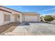 Home exterior featuring gravel landscaping and two-car garage at 4828 Marco Polo St, North Las Vegas, NV 89031