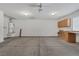 Spacious garage with ample storage cabinets and workbench, offering a versatile area for projects at 4828 Marco Polo St, North Las Vegas, NV 89031