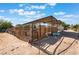 Exterior of a large animal shelter with gated stalls and a metal roof at 4905 Ricky Rd, Las Vegas, NV 89130