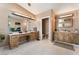 Bathroom featuring dual sinks, granite countertops, and a vanity area with well lit mirrors at 4905 Ricky Rd, Las Vegas, NV 89130