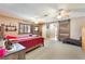 Comfortable bedroom featuring a wooden bed frame, rustic sliding door, and carpeted floor at 4905 Ricky Rd, Las Vegas, NV 89130