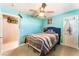 Bedroom featuring a ceiling fan, an ensuite bathroom, and decorated with pop art at 4905 Ricky Rd, Las Vegas, NV 89130