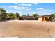 Exterior view of the house including a large open lot and an animal shelter at 4905 Ricky Rd, Las Vegas, NV 89130