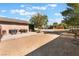 Wide shot of a large open lot with an outdoor kitchen, animal shelter, and a storage shed at 4905 Ricky Rd, Las Vegas, NV 89130