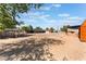 Wide shot of a lot that has an open area, an animal enclosure, and a storage building at 4905 Ricky Rd, Las Vegas, NV 89130