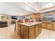 Beautiful kitchen with a center island, wood cabinets, granite countertops, and modern appliances at 4905 Ricky Rd, Las Vegas, NV 89130