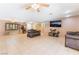 Open-concept living room with tile flooring and abundant natural light from multiple windows at 4905 Ricky Rd, Las Vegas, NV 89130