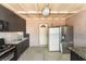 Functional outdoor kitchen with stove, sink, and refrigerator under a covered patio with concrete flooring at 4905 Ricky Rd, Las Vegas, NV 89130