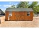 Exterior of a wooden shed with double doors and a window air conditioning unit at 4905 Ricky Rd, Las Vegas, NV 89130
