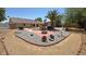 This home's backyard boasts custom landscaping including a central fire pit at 4910 Marywood Ct, Pahrump, NV 89061