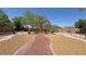 Large, beautifully landscaped backyard with mature palm trees and winding brick pathways at 4910 Marywood Ct, Pahrump, NV 89061