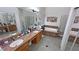 Spacious bathroom with double sinks, granite countertops, a soaking tub, a separate shower, and tile flooring at 4910 Marywood Ct, Pahrump, NV 89061