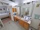 The bathroom showcases a dual sink vanity and mirrors, with a doorway that offers a glimpse into the bedroom at 4910 Marywood Ct, Pahrump, NV 89061