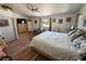 This bedroom features a ceiling fan, a window, and a queen-size bed with a patterned comforter and decorative pillows at 4910 Marywood Ct, Pahrump, NV 89061