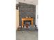 A decorative fireplace with a stone facade creates a cozy ambiance in this residence at 4910 Marywood Ct, Pahrump, NV 89061