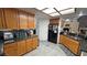 Charming kitchen featuring wood cabinets, granite countertops, and modern black appliances at 4910 Marywood Ct, Pahrump, NV 89061