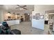 Bright living room with tile flooring, a cozy fireplace, and seamless access to the dining and kitchen areas at 4910 Marywood Ct, Pahrump, NV 89061