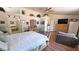 Main bedroom with wood floors, a ceiling fan, and a view of the attached bathroom at 4910 Marywood Ct, Pahrump, NV 89061