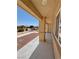 Covered front porch showcasing neutral stucco exterior, manicured landscaping, and ample natural light at 4910 Marywood Ct, Pahrump, NV 89061
