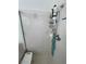 Detail of a tiled shower with adjustable shower head, corner shelving, and a built-in bench for accessibility at 4910 Marywood Ct, Pahrump, NV 89061